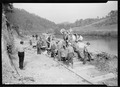 "Mixing the first batch of concrete for Crib ^1 on the heavy duty bridge at the site of Norris Dam, just below the... - NARA - 532709.tif